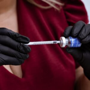 Professional administering Xeomin injection, emphasizing careful handling and precision.