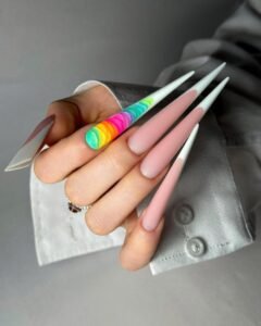 Close-up of colorful stiletto nails with rainbow accents, perfect for fashion inspiration.