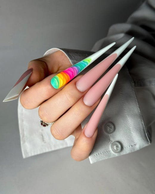 Close-up of colorful stiletto nails with rainbow accents, perfect for fashion inspiration.