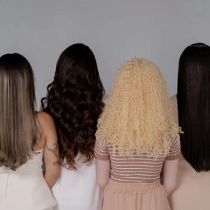 Four women showing diverse hairstyles from behind, emphasizing hair texture and color.
