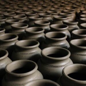An image showcasing handcrafted clay pots arranged in a striking repetitive pattern.