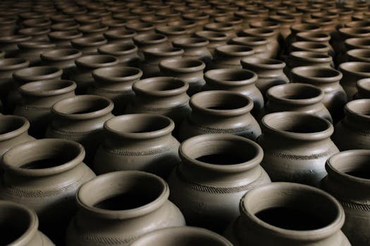 An image showcasing handcrafted clay pots arranged in a striking repetitive pattern.
